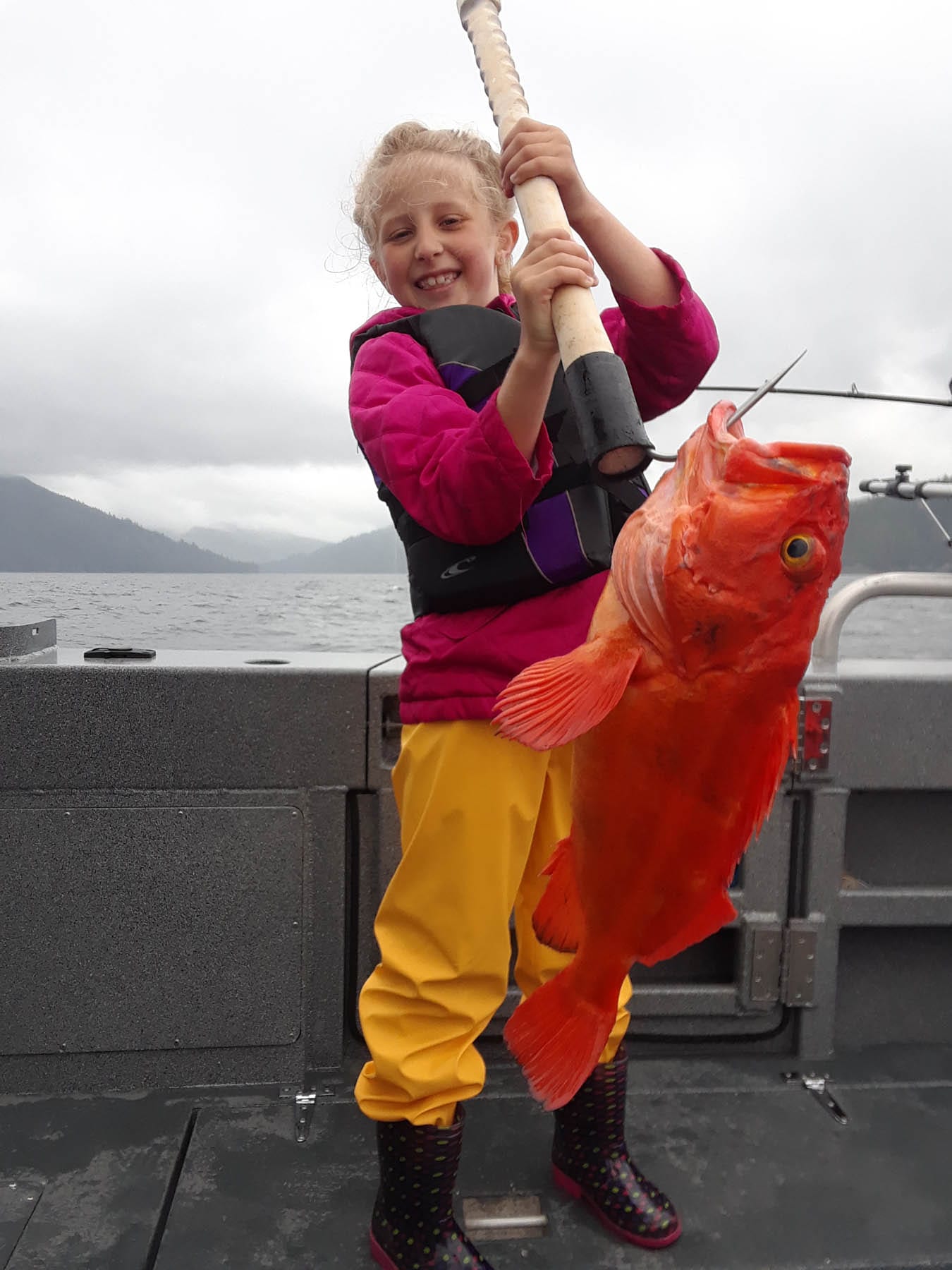 211416408-20180706_125739 Young girl holding a red snapper.