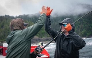 Alaska Fishing Trip: A pair of avid anglers give each other a high-five after another successful day on the water with Screamin' Reels.