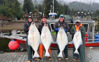 Halibut Recipes: Four men proudly holding up large halibut fish.